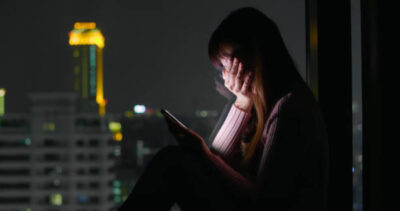 Woman use phone and feel depression at nigh
