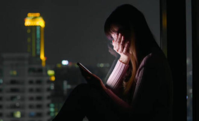 woman use phone and feel depression at nigh