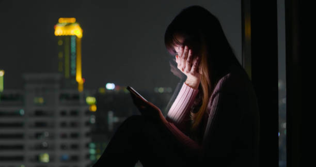 woman use phone and feel depression at nigh