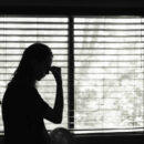 Stressed young woman in the bedroom.