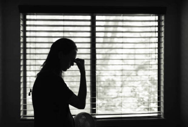 Stressed Young Woman In The Bedroom.