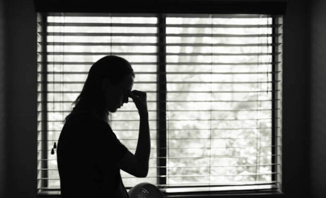 Stressed young woman in the bedroom.