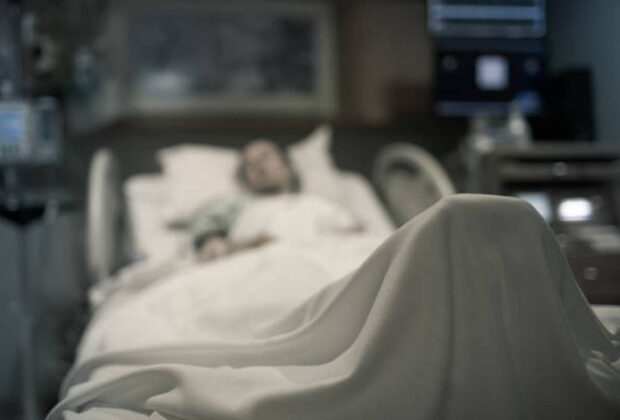 Sick Woman Lying In The Hospital Bed.