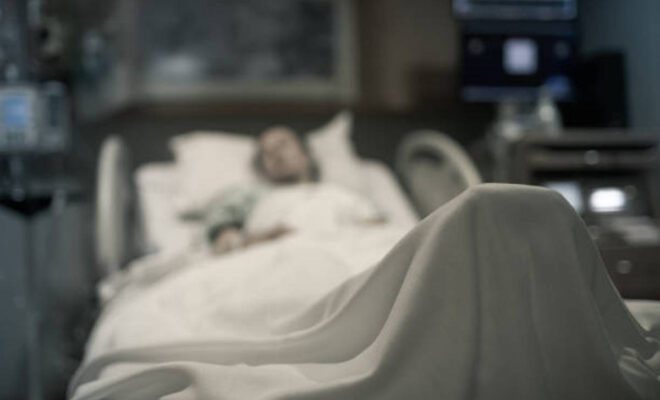 Sick woman lying in the hospital bed.
