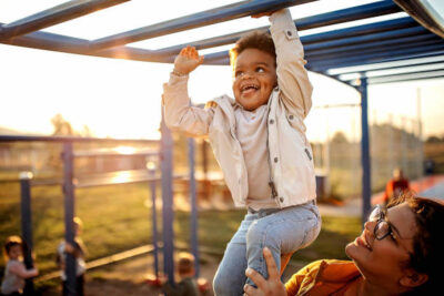 Kid Playing With Mother In Public Park