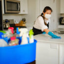 A professional housecleaner at work cleaning a home.