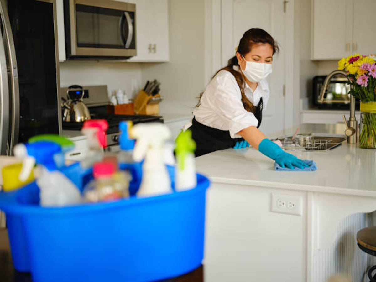 A Professional Housecleaner At Work Cleaning A Home.