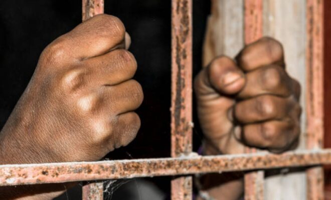 Closeup Of Brown Hands Of Prison Inside The Jai