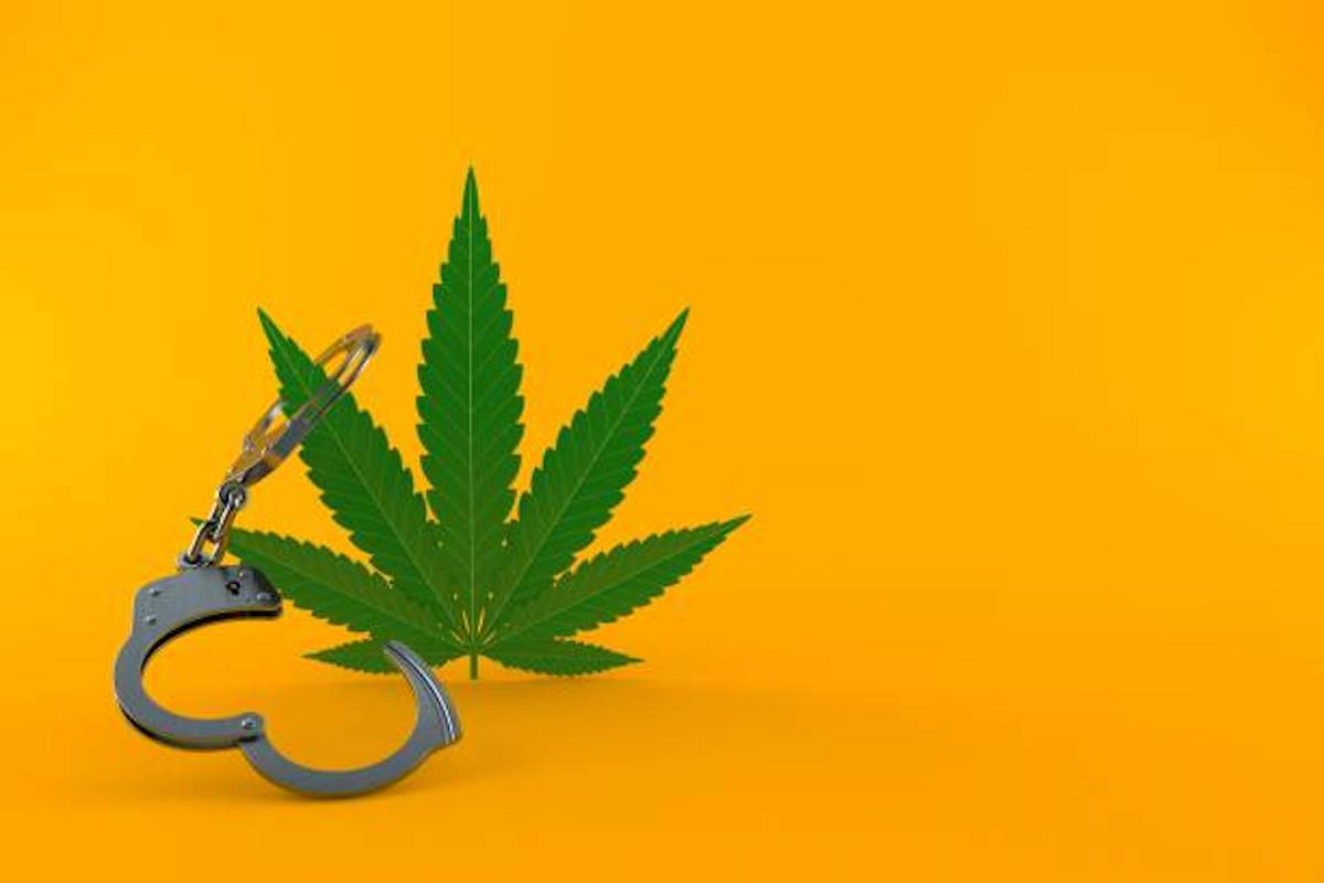 Cannabis Leaf With Handcuffs Isolated On Orange Background. 3d Illustration