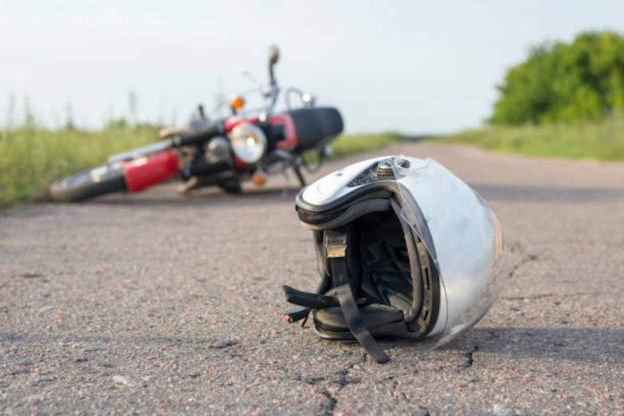 Photo Of Helmet And Motorcycle On Road, The Concept Of Road Accidents